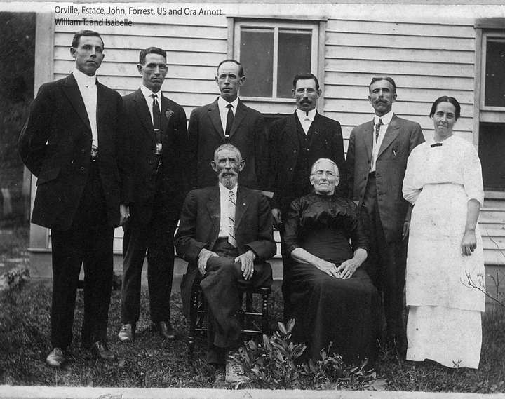 Orville, Estace, John, Forrest, US and Ora Arnott standing in back. | William T. and Isabelle sitting in front